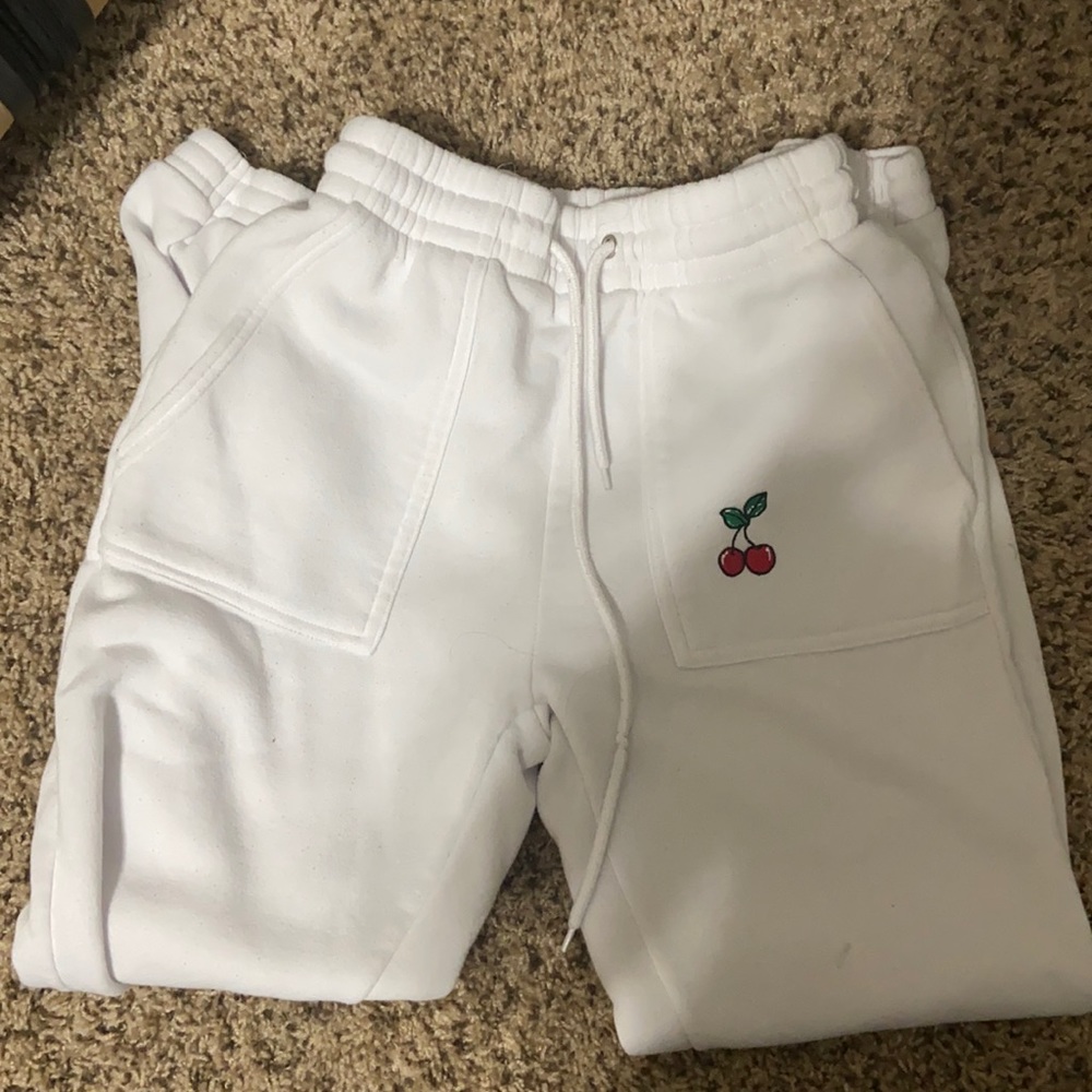 white sweats with cherry embroidery